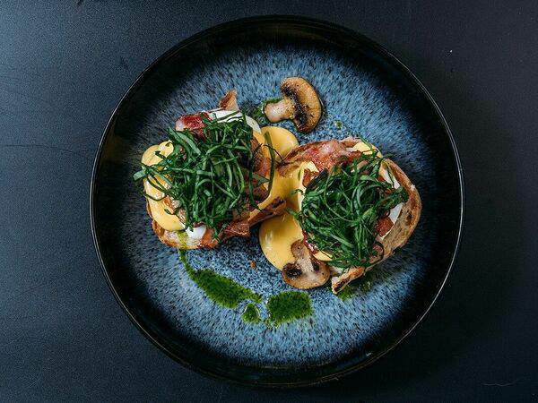 Прага - Яйца Бенедикт с беконом, грибами и шпинатом под соусом Чеддер